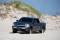 Savage Ditch, Delaware, U.S - July 4, 2023 - A black Chevy pick up truck with a kayak and surf fishing beach permit driving on the