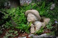 Savannah, Georgia, USA - March 10, 2022: Little boy sculpture amid lush, old fashioned garden Royalty Free Stock Photo