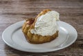 Savarin with whipped cream placed on a plate Royalty Free Stock Photo