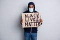 Save black lives. Photo of mad dark skin african poor covid infected protester hold placard stand against black citizens