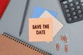 Save the date - concept of text on sticky note. Closeup of a personal agenda. Top view. Office concept Royalty Free Stock Photo