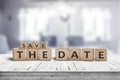 Save the date memo sign on a wooden table