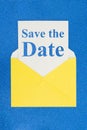 Save the Date message on white card with a yellow envelope