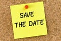 Save the date PostIt Note Pinned To Cork Board Royalty Free Stock Photo