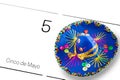 Save the date white calendar for Cinco de Mayo, May 5th with blue sombrero decorated with colorful sequins and golden. Cinco de