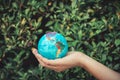 Save The Earth and Care Environment Concept, Close-up Portrait of Woman is Holding Mockup Global in Her Hands on Tree Leave