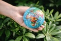 Save The Earth and Care Environment Concept, Close-up of Woman Hands is Holding Mockup Global Against on Tree Leave Background. Sa Royalty Free Stock Photo