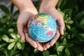 Save The Earth and Care Environment Concept, Close-up of Woman Hands is Holding Mockup Global Against on Tree Leave Background. Royalty Free Stock Photo