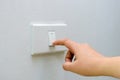 Save electricity Close up of finger is turning on or off on light switch. woman hand with finger on light switch Copy space. Royalty Free Stock Photo