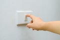 Save electricity Close up of finger is turning on or off on light switch. woman hand with finger on light switch Copy space. Royalty Free Stock Photo