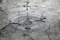 Save environment. Water drops falling on dry cracked land, black and white effect Royalty Free Stock Photo