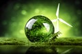 save the green planet concept. glass bowl with greens inside on grass on background of windmill