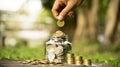 Save money concept hands  holding coins placed  on gold coins at a level different from financial  investing coins outside the Royalty Free Stock Photo