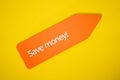 Save money! sign on orange tag on yellow background. Discount, promotion and cost saving concept