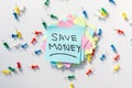 Save Money sticky note with a colorful push pins and white background Royalty Free Stock Photo