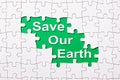 Save our earth word reveal under jigsaw puzzle Royalty Free Stock Photo