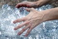 Save our environment. Female hands grabbing plastic bottles