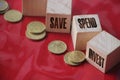 Save spend invest on Wooden Cubes and coins on red backgroud. Financial concept