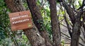 Save trees save earth written on a wooden board hanging with a tree near a hiking trail in Islamabad,Pakistan..