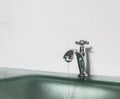 Save Water Save The World Concept, Water Drop from Old Silver Faucet in The Bathroom with Copyspace Royalty Free Stock Photo