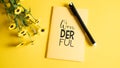 Save your ideas in notebook. Diary for your dreams or secret. Wonderful yellow notebook with black pan and small flowers