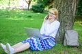 Save your time with shopping online. Sales manager occupation benefits. Woman with laptop in park order item on phone Royalty Free Stock Photo