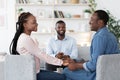 Saved Marriage. Happy African Spouses Holding Hands After Reconciliation At Counselor`s Office