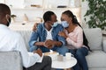 Saved Marriage. Happy Black Couple In Medical Masks Embracing At Councelor`s Office Royalty Free Stock Photo