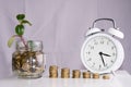 Saved money and a clock on a white background Royalty Free Stock Photo