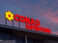 Conad Superstore logo sign illuminated in night vision on sunset sky Royalty Free Stock Photo