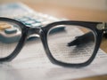 Saving Account Book with pen focused in eyeglasses lenses