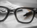 Saving Account Book with pen focused in eyeglasses lenses