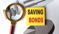 SAVING BONDS text on a sticky on chart Royalty Free Stock Photo