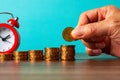 Saving with clock, table of coins Royalty Free Stock Photo