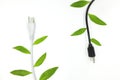 Saving electricity and green alternative energy concept. Electric plug cord with green leaves. Royalty Free Stock Photo