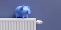 Saving on energy cost in winter. Piggy bank on heating radiator, blue wall background Royalty Free Stock Photo