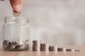 Saving finance business investment concept. Hand of male or female putting coins in jar Royalty Free Stock Photo