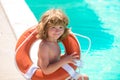 Saving life. Helping concept. Child with rescue circle. Summer beach. Be careful on water. Royalty Free Stock Photo