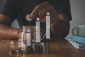 Saving money concept. businessman hand putting in a jar with money stack step growing growth saving money and graph US dollar sign Royalty Free Stock Photo