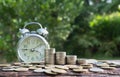 Saving money concept with money coin stack growing and alarm clock for business. financial and accounting concept. Royalty Free Stock Photo