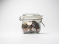 Saving money concept, coins in Glass Jar, White and black Royalty Free Stock Photo