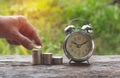 Saving money concept and hand of man putting money coin stack Royalty Free Stock Photo