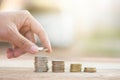 Male hand putting money coin stack growing business Royalty Free Stock Photo