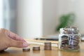 Saving money concept. Male hand putting money coin stack on office desk at home for the future growing business, education and Royalty Free Stock Photo