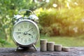 Saving money concept with money coin stack growing and alarm clock for business. financial and accounting concept. Royalty Free Stock Photo