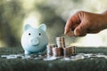 Saving money concept preset by female hand putting money coin stack growing business. Asian woman making stack of coin, planning Royalty Free Stock Photo