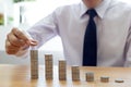 Saving money concept preset, the young man arranged the coins like a graph of the growing business Royalty Free Stock Photo