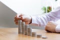 Saving money concept preset, the young man arranged the coins like a graph of the growing business Royalty Free Stock Photo