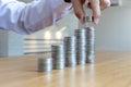 Saving money concept preset, the young man arranged the coins like a graph of the growing business Royalty Free Stock Photo