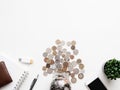 Saving money concept with smartphone, notebook, keyboard, wallet and coins stack on white table background. Royalty Free Stock Photo